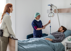 nurse talking to a patient in her room